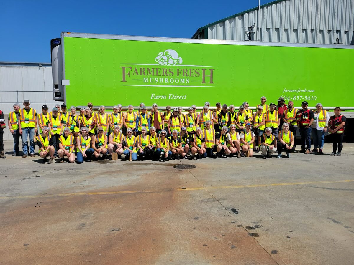 Large group in front of Farmers Fresh truck