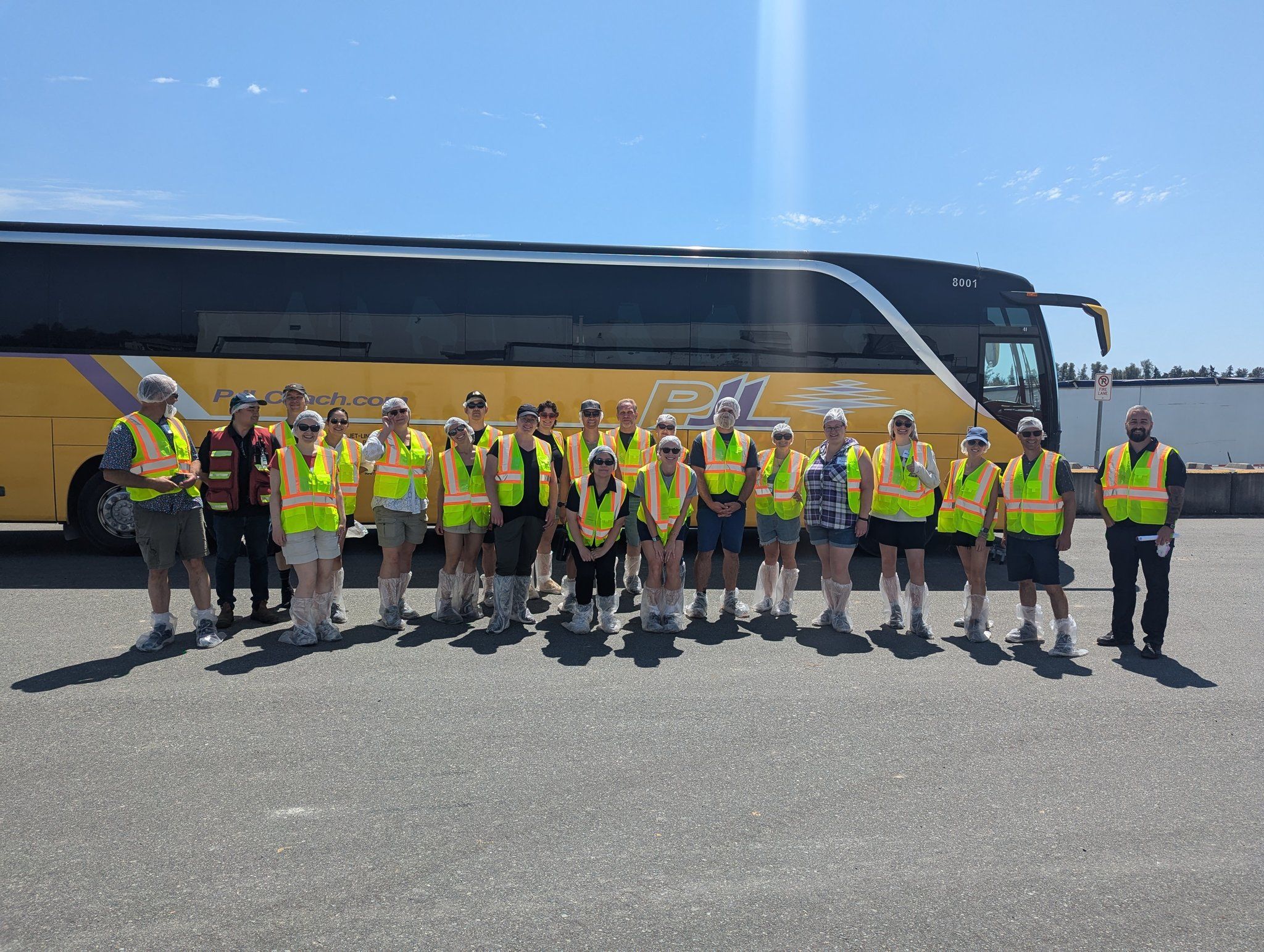 Group that toured the farm in front of the bus