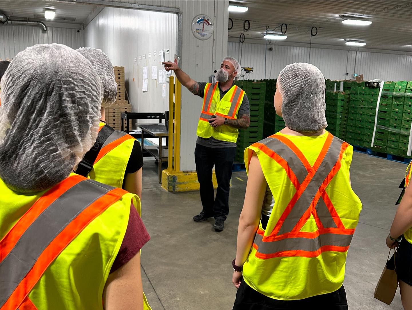 Farmers Fresh staff member explaining how things work to the group