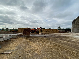 loader pickingup bales